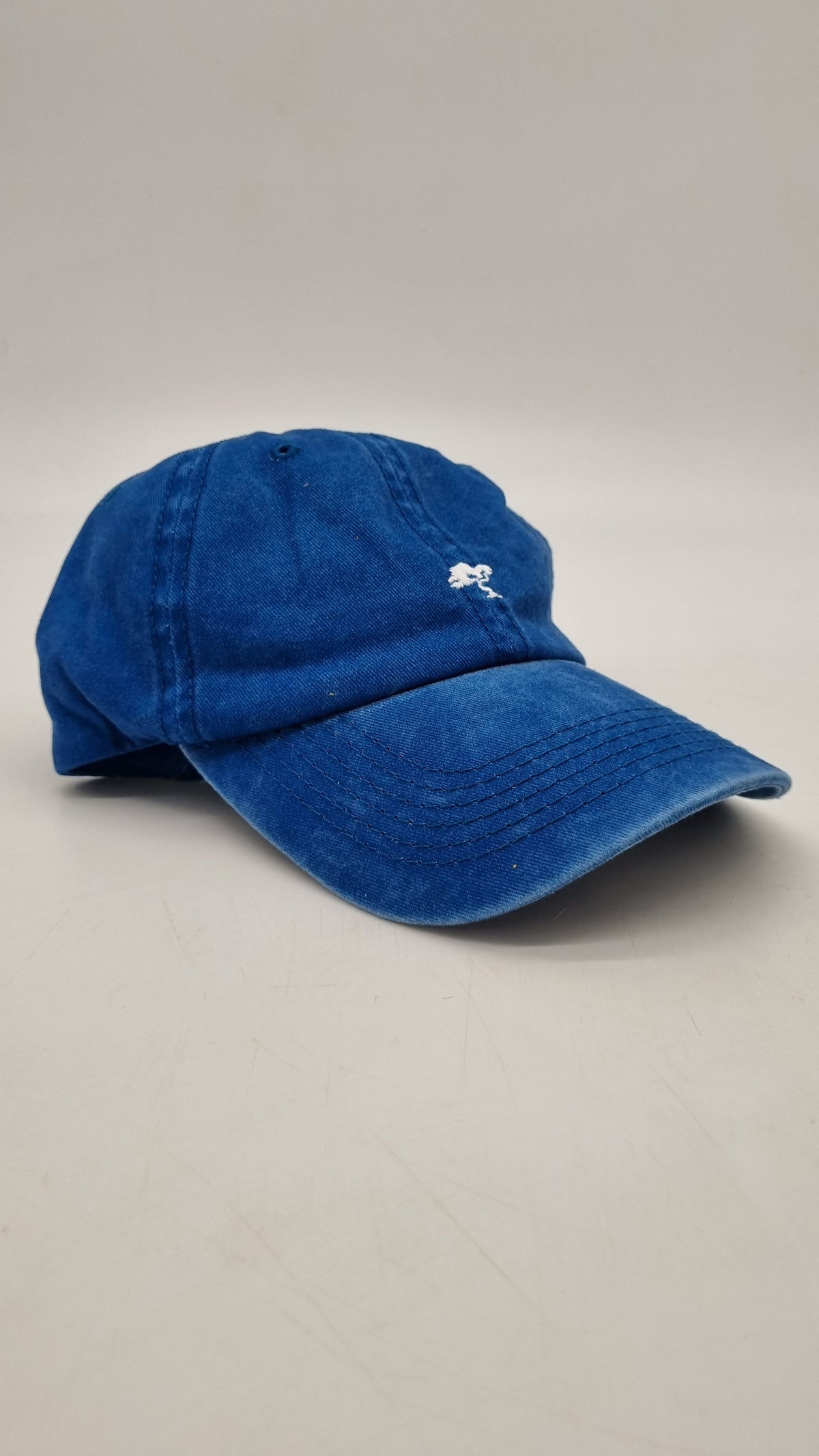 A blue colored cap with a logo on the front.