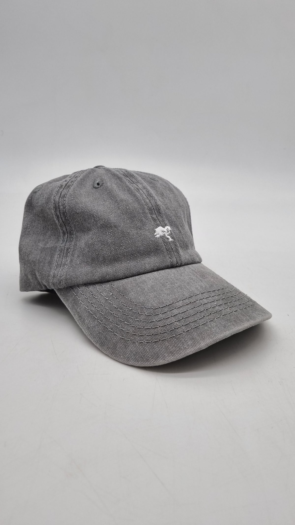 A grey colored cap with a logo on the front.