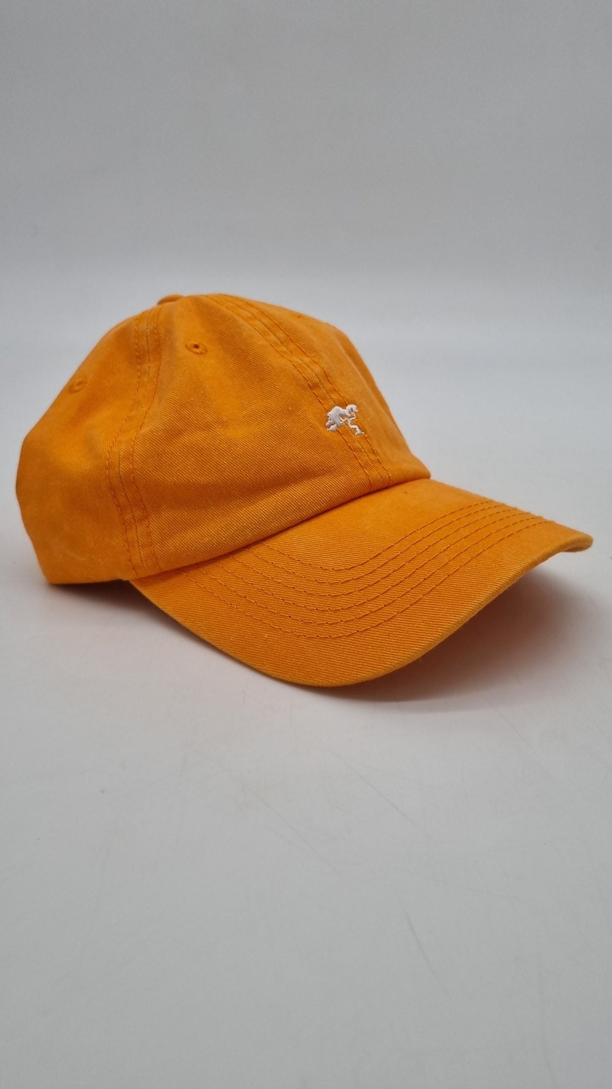 An orange colored cap with a logo on the front.