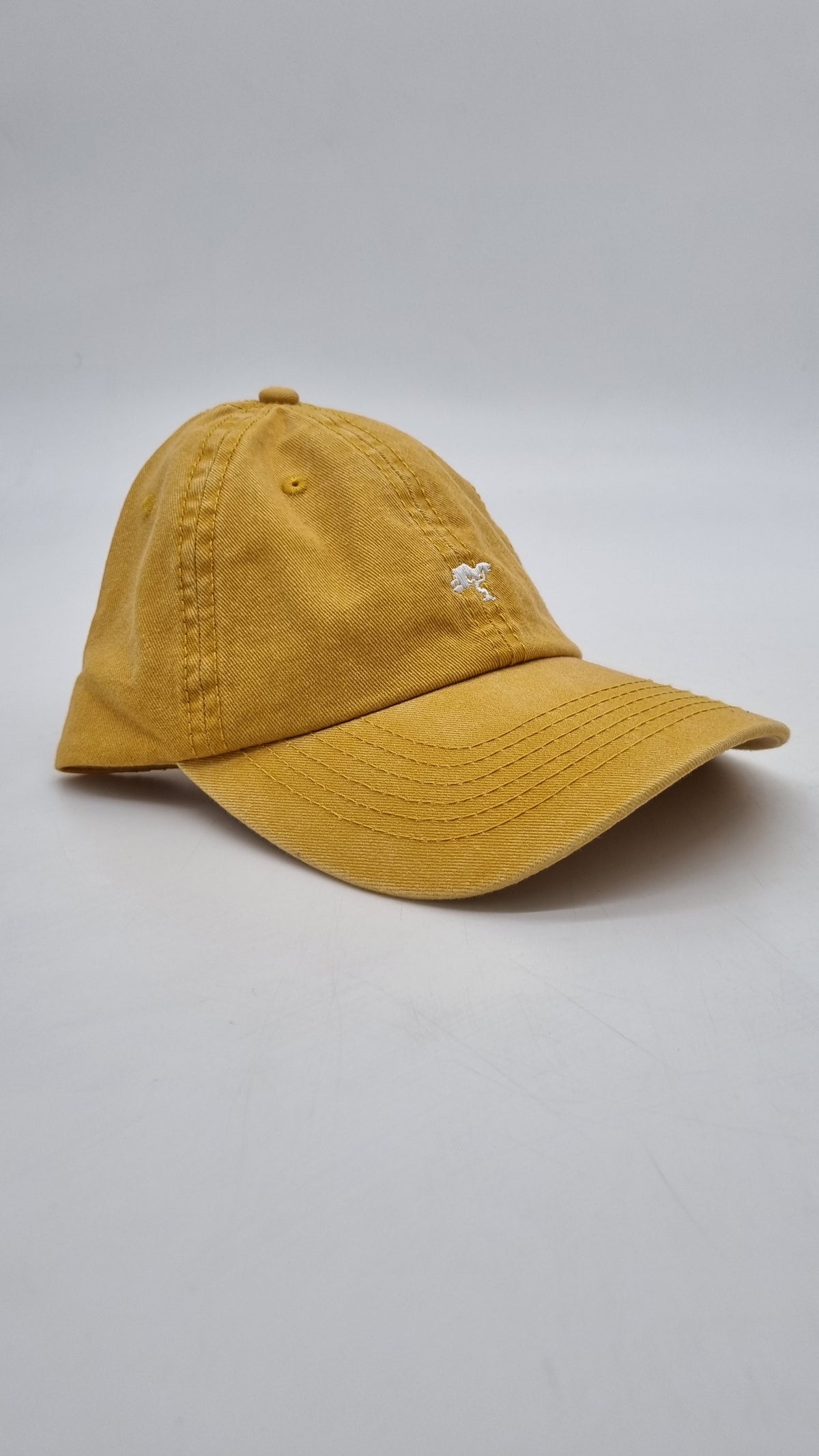 A beige colored cap with a logo on the front.