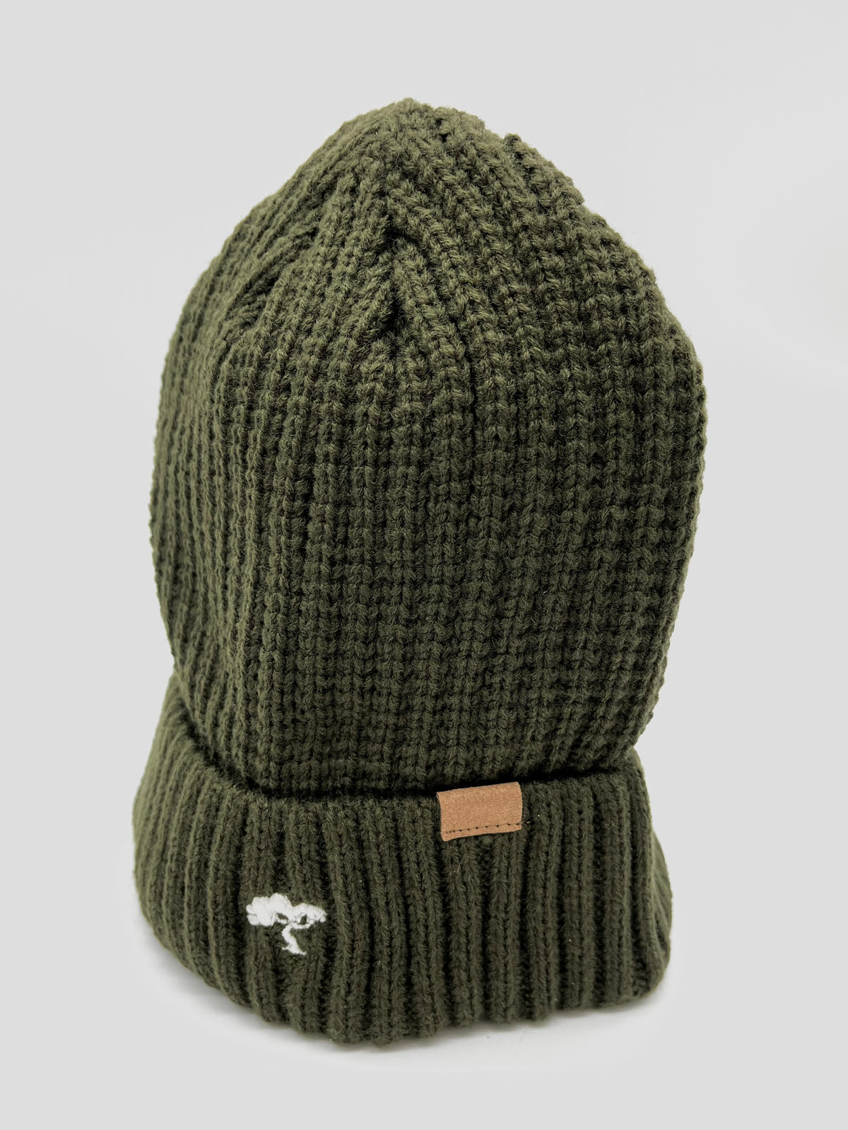 An olive green cotton beanie with a visible brand tag on it.