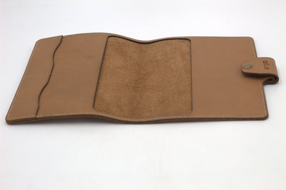 Brown leather journal cover opened to reveal a suede finish