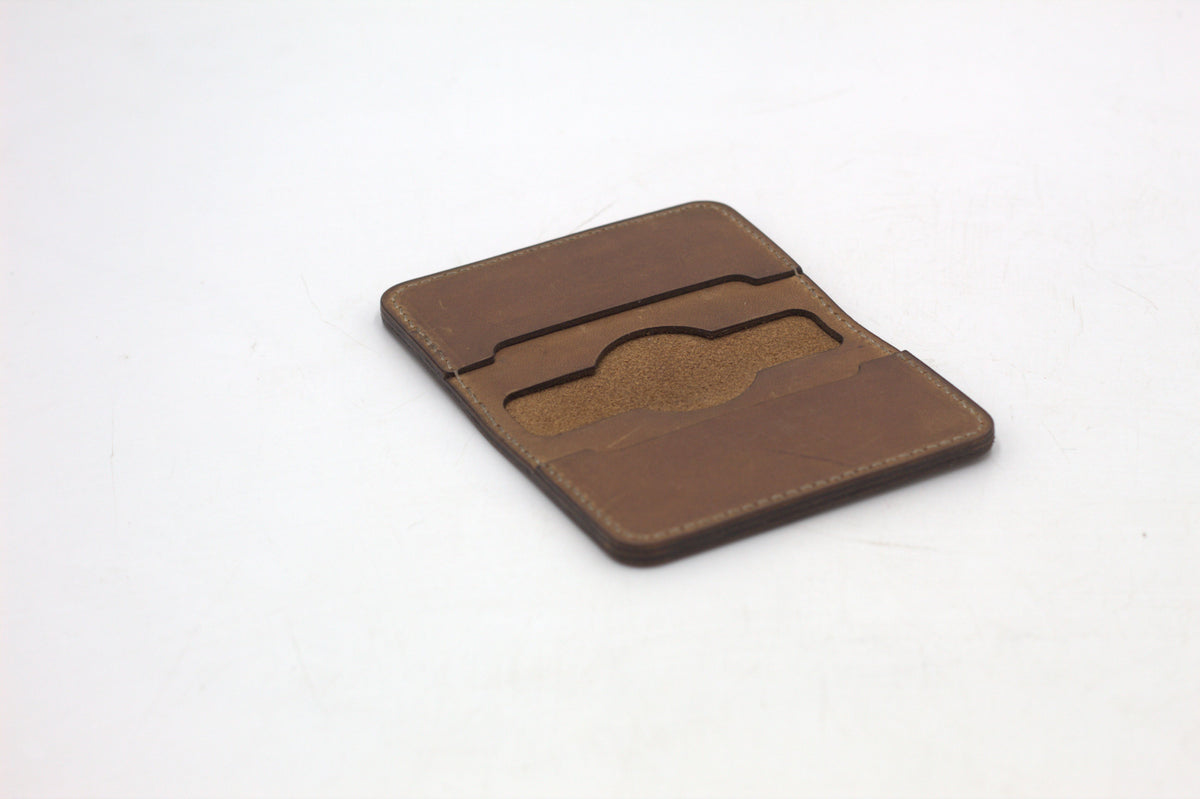 A brown bi-fold wallet on a white background.