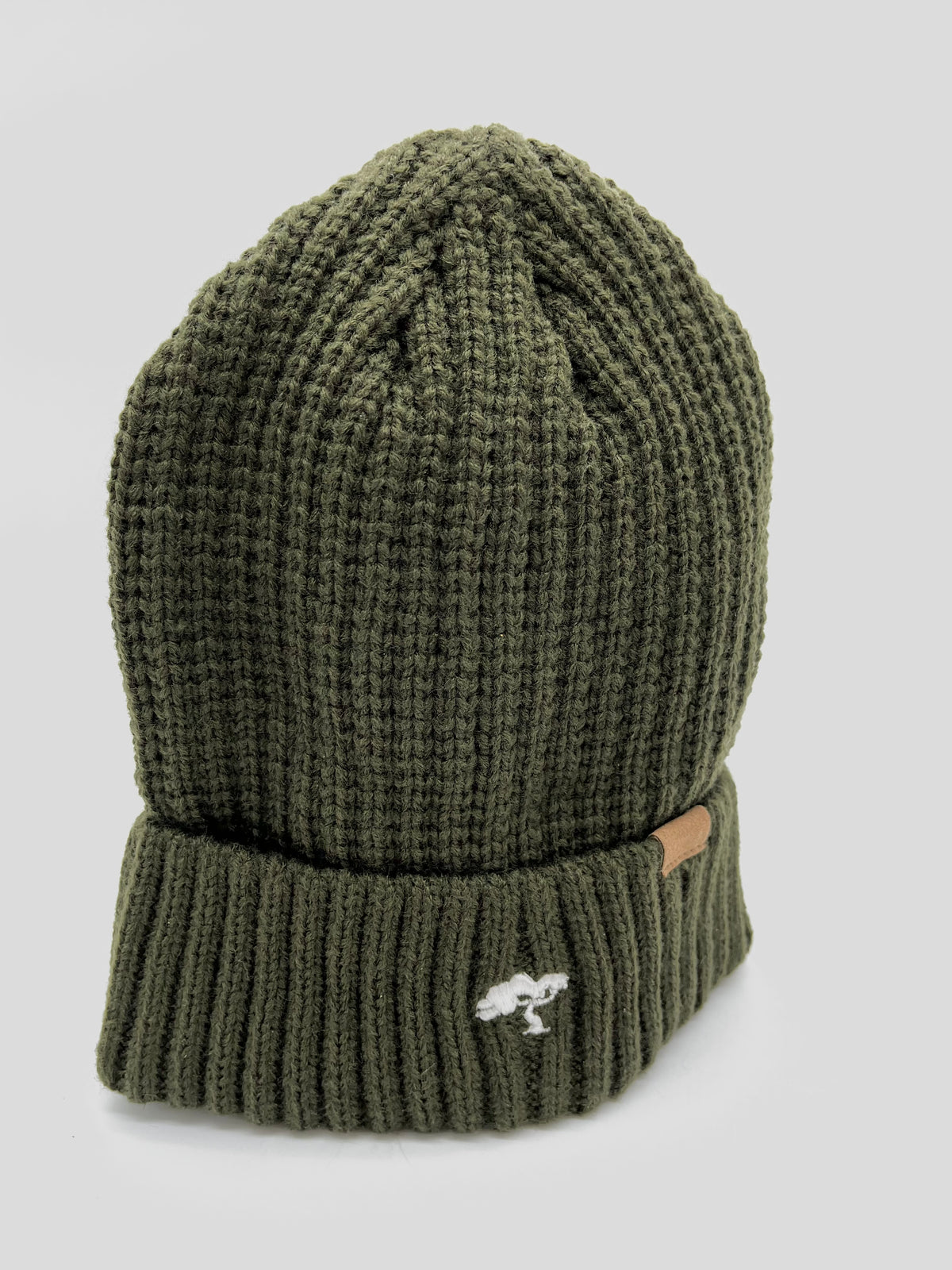 An olive green cotton beanie with a visible brand tag on it.