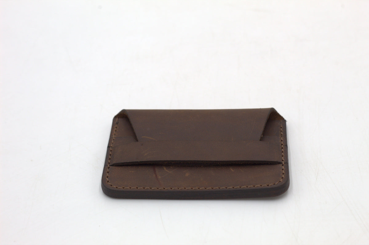 A brown leather wallet with multiple card slots visible.