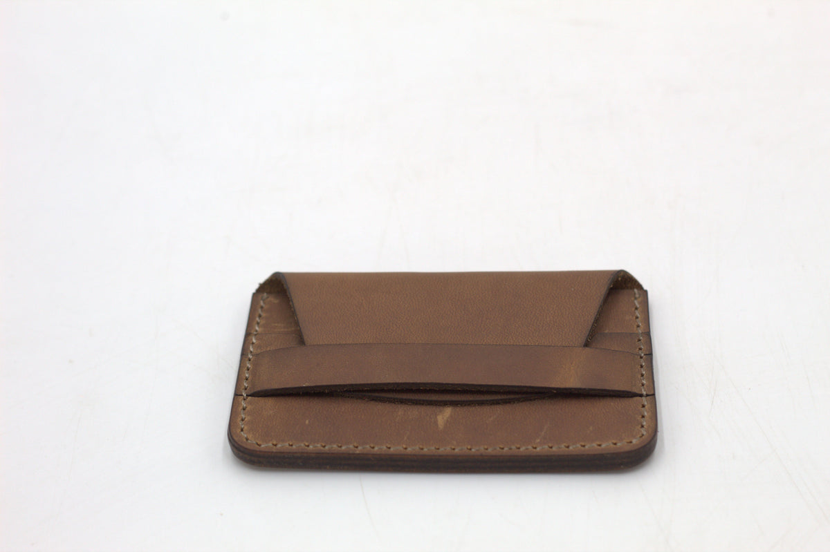 A brown leather wallet with multiple card slots visible.