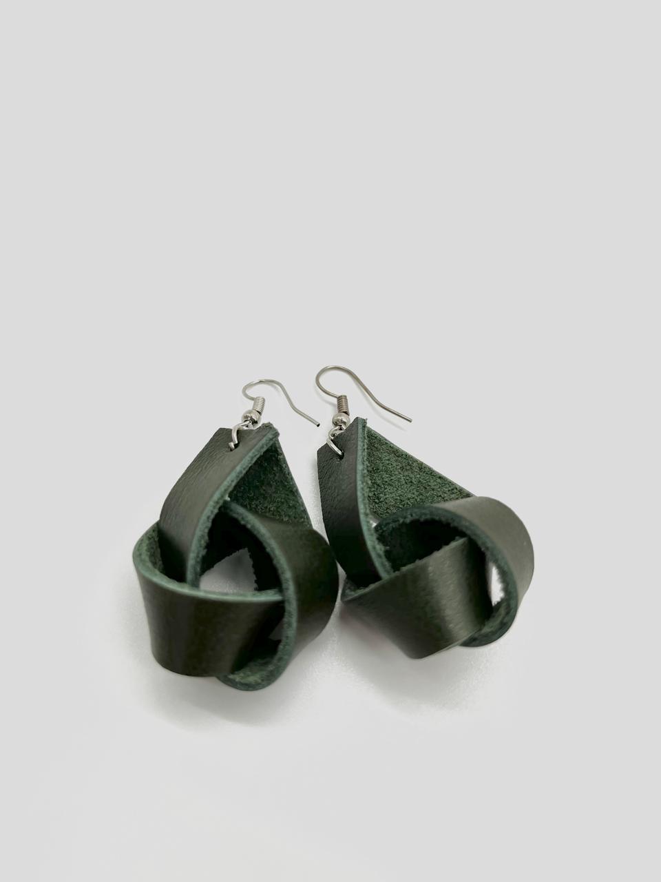 A pair of black leather earrings with a simple loop design, suspended from silver hooks.
