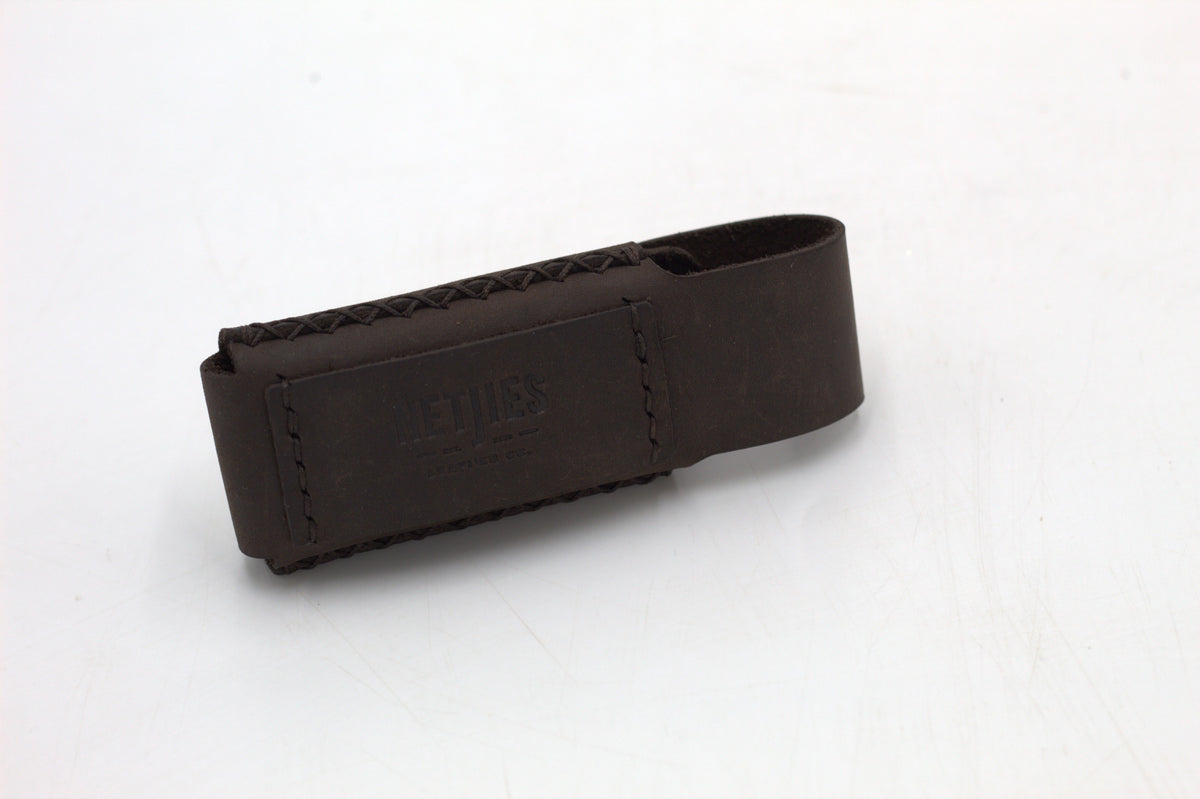 A black leather multitool pouch against a white background