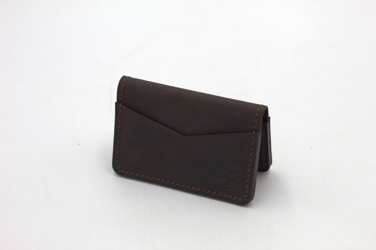 A black leather wallet with a front flap and metal accents, isolated on a white background.