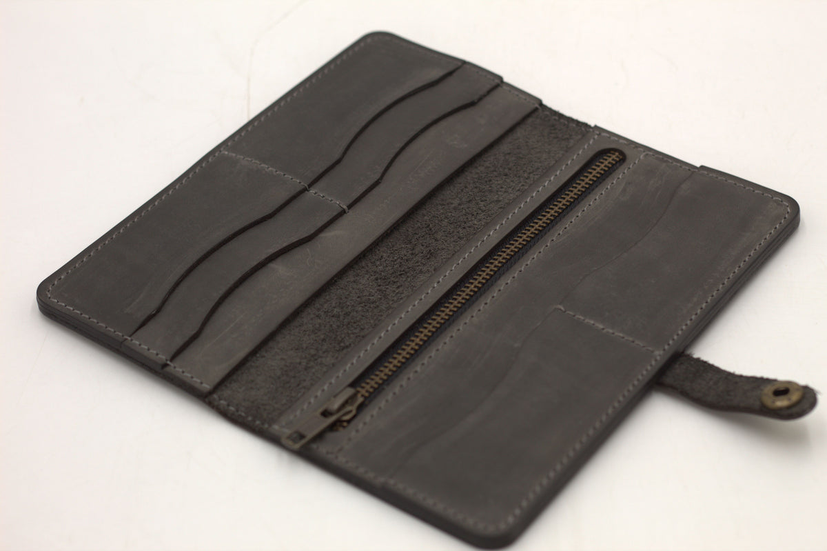 Black leather wallet opened to reveal card slots and coin pouch
