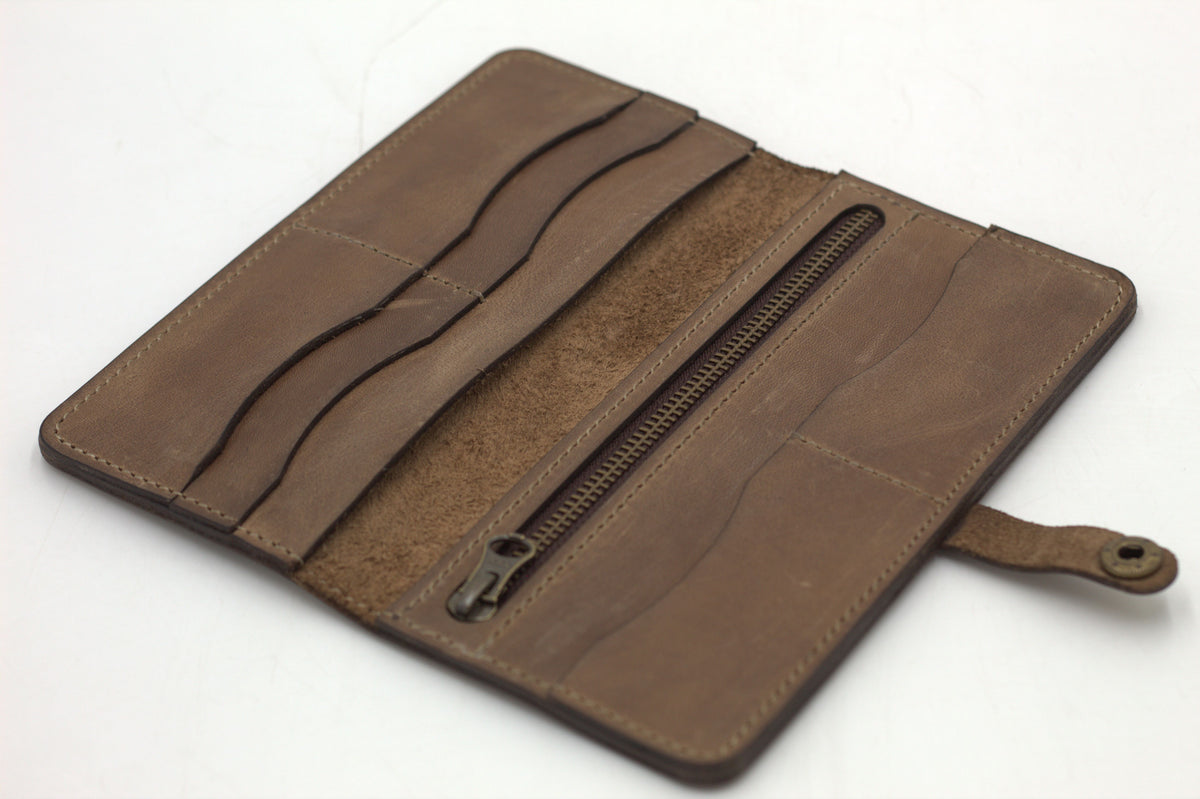 Brown leather wallet opened to reveal card slots and coin pouch