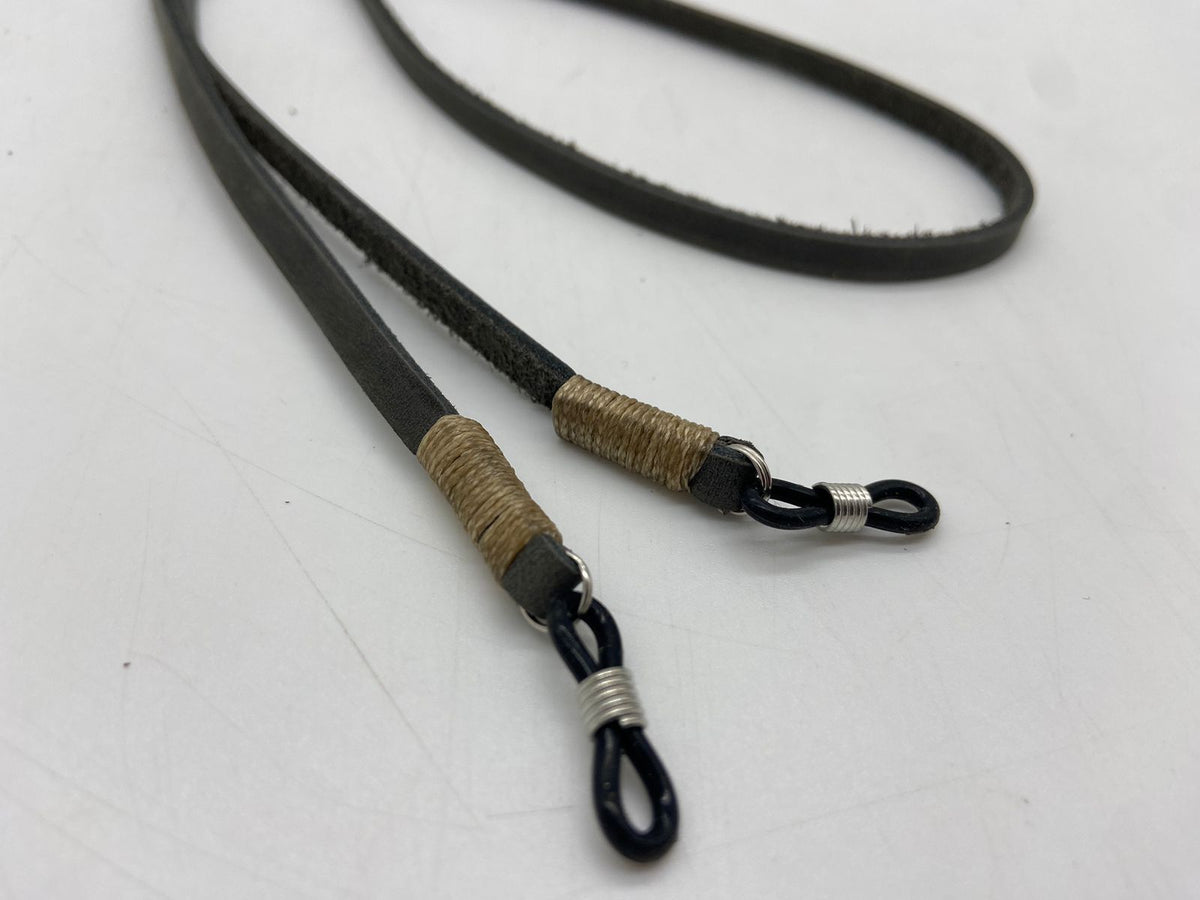 Black and brown leather lanyard with metal clip on a white background