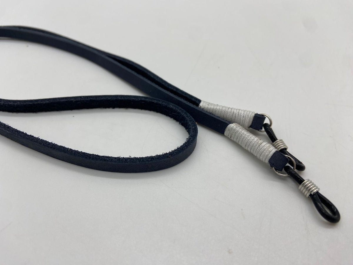 Navy blue lanyard with silver metal clip on a light gray background