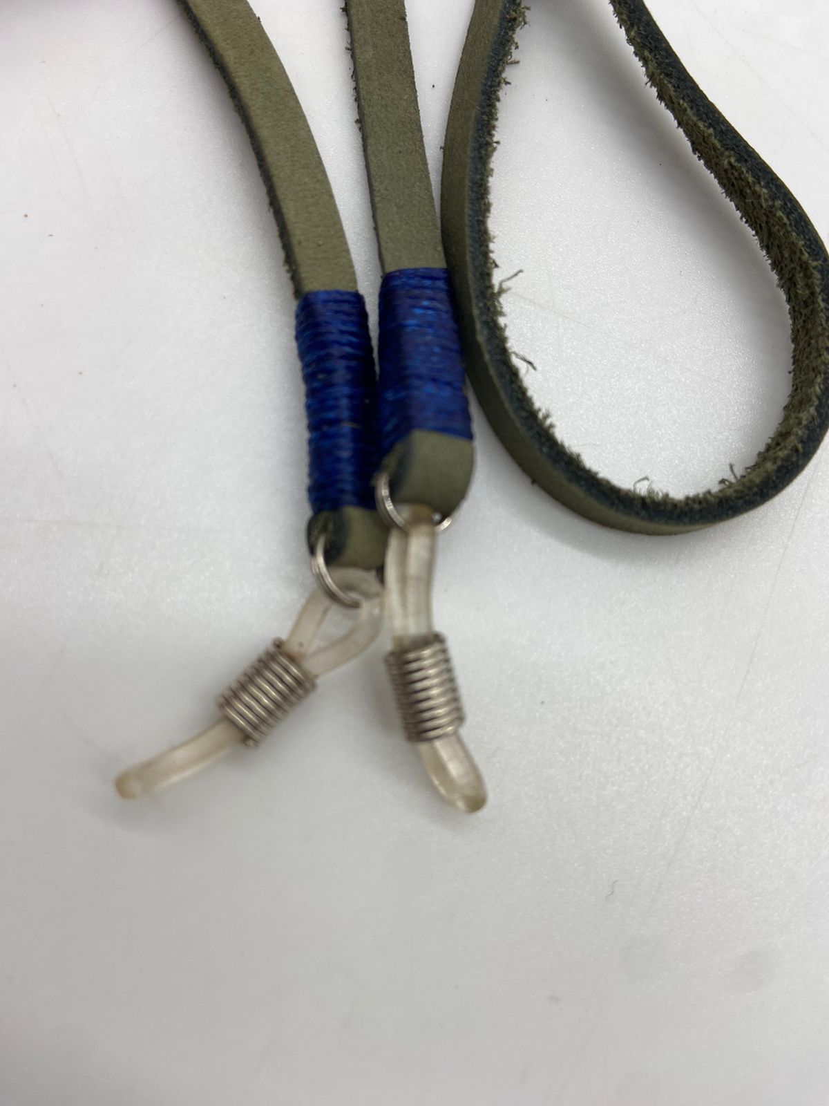 Close-up of a lanyard with blue and green sections on a white background