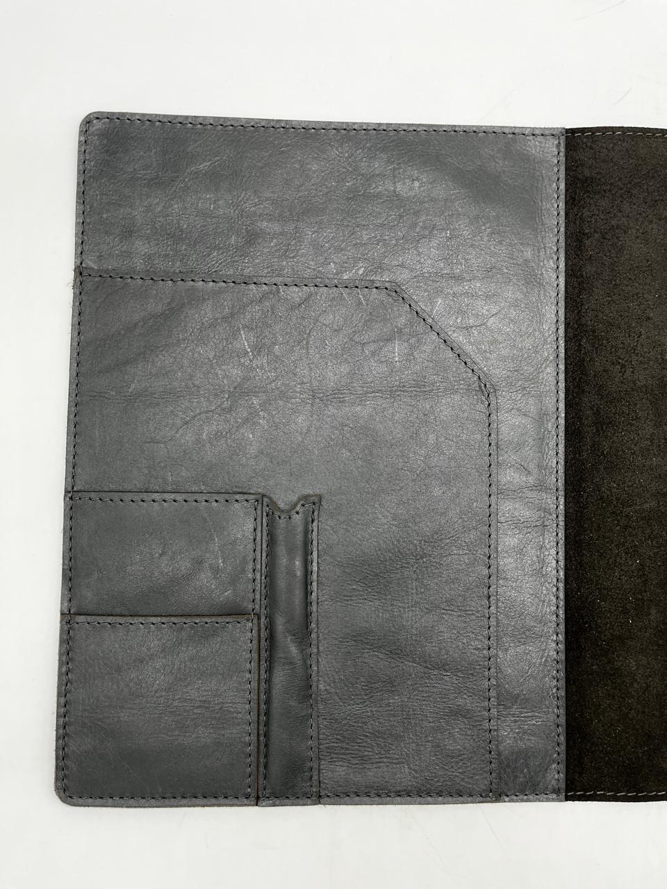 A black leather A4 book folder opened to reveal multiple compartments and a suede finish