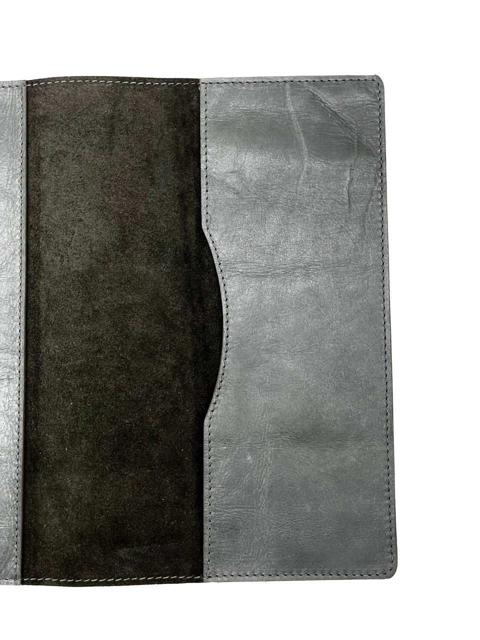 A black leather A4 book folder opened to reveal multiple compartments and a suede finish