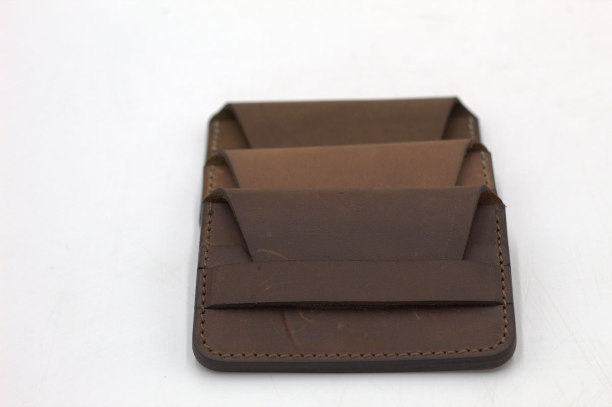 A brown leather wallet with multiple card slots visible.