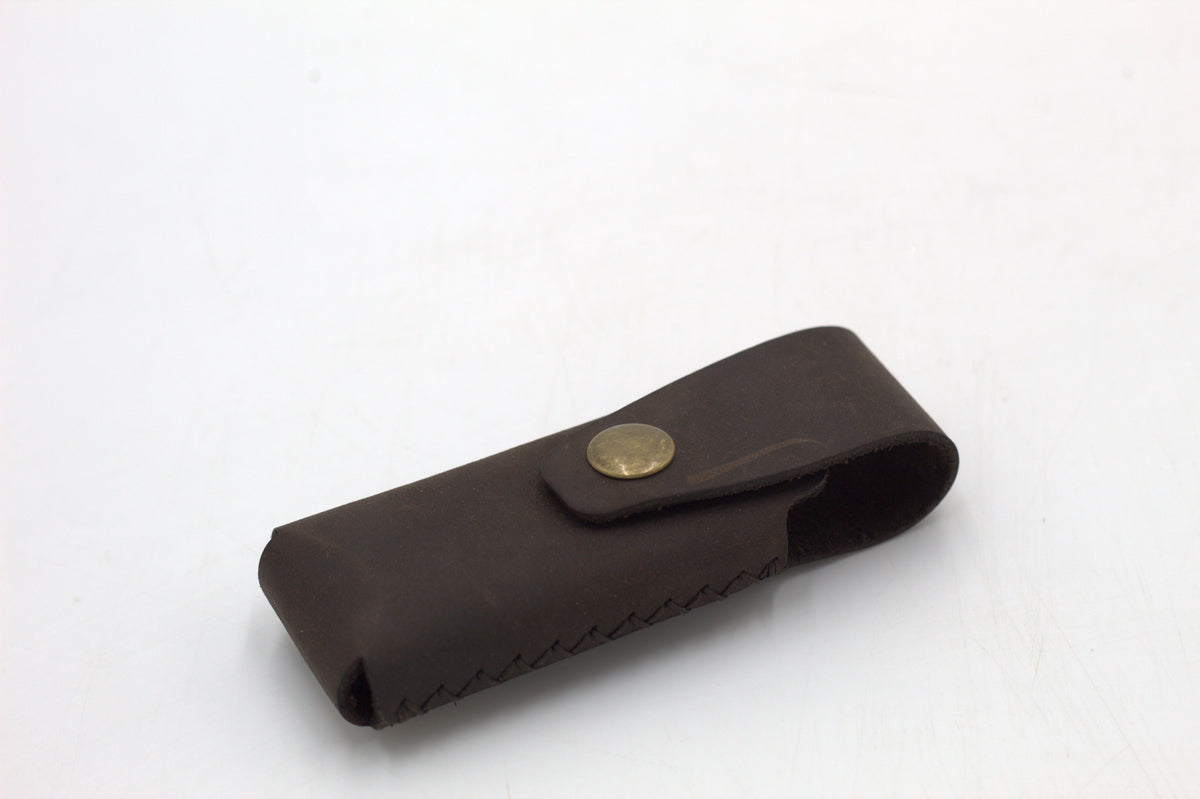 A black leather multitool pouch against a white background