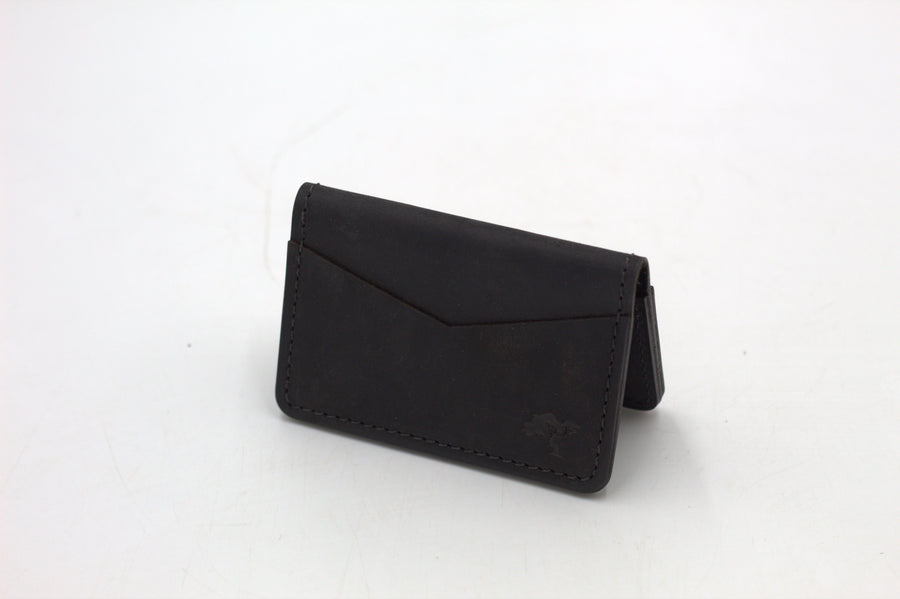 A black leather wallet with a front flap and metal accents, isolated on a white background.