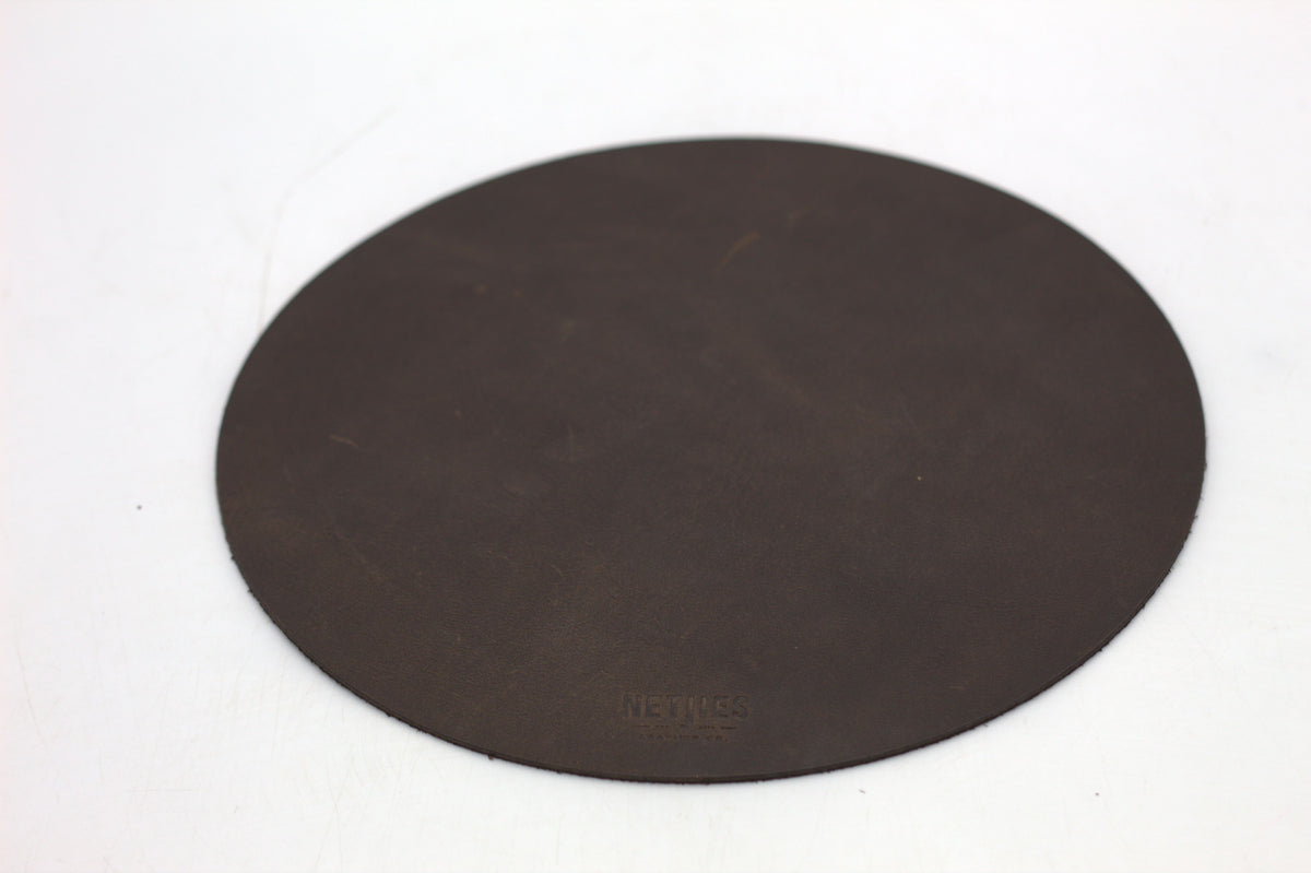 A large round brown mousepad.