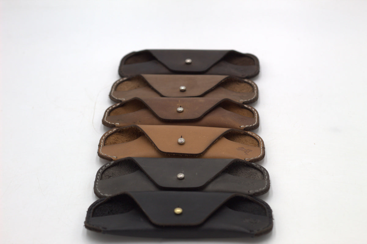 A collection of brown leather eyewear cases in various shades, displayed on a white background.