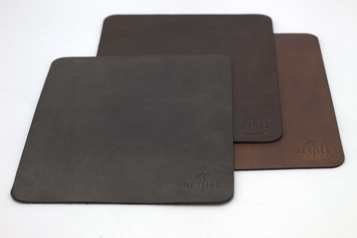 Three large rectangle mousepads in black, brown, and gray colors, with a brand logo imprinted on the brown mousepad.